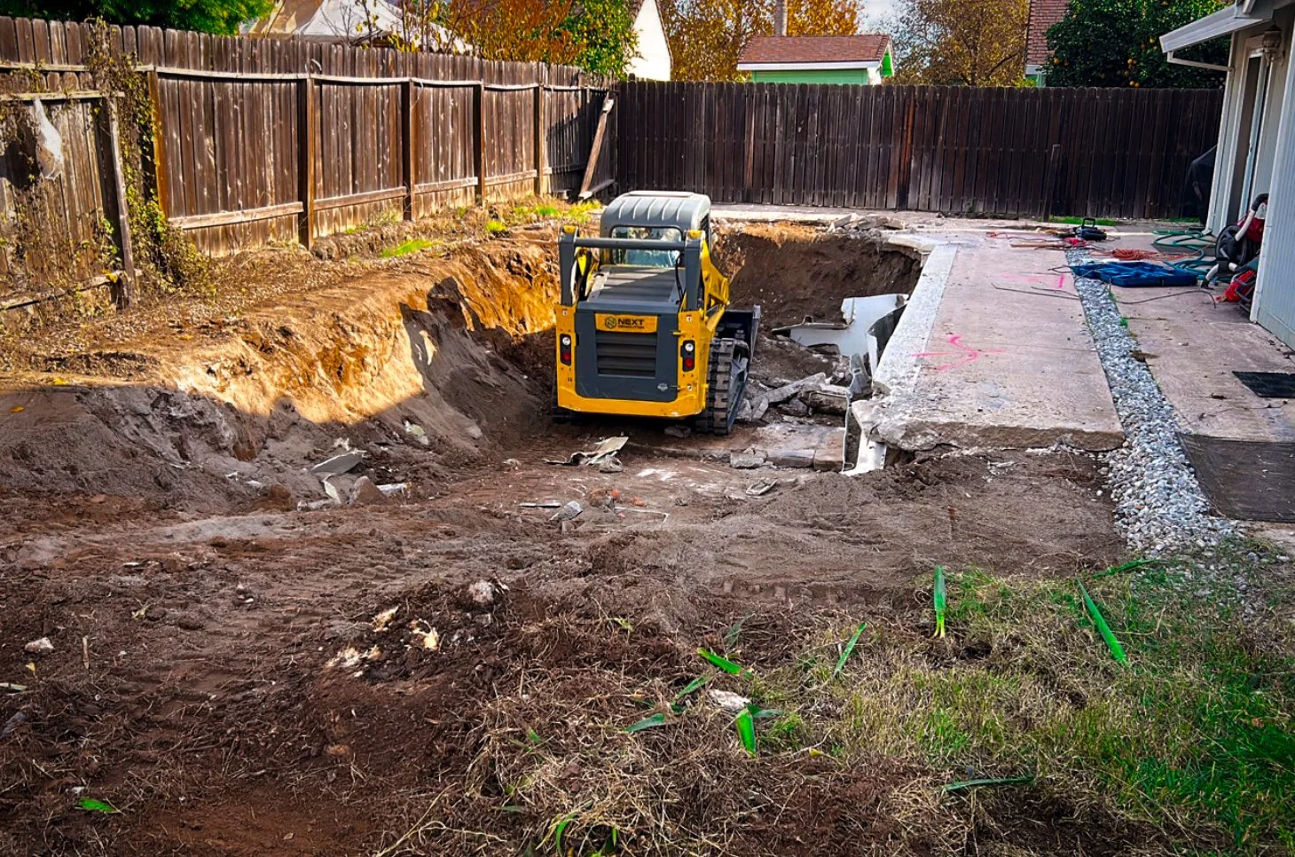 Skid steer working inside a pool during removal